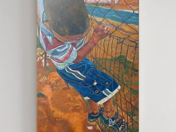 Child climbing a fence captured in an almost sepia feel.