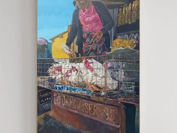 An African woman selling vegetables on the side of a road.