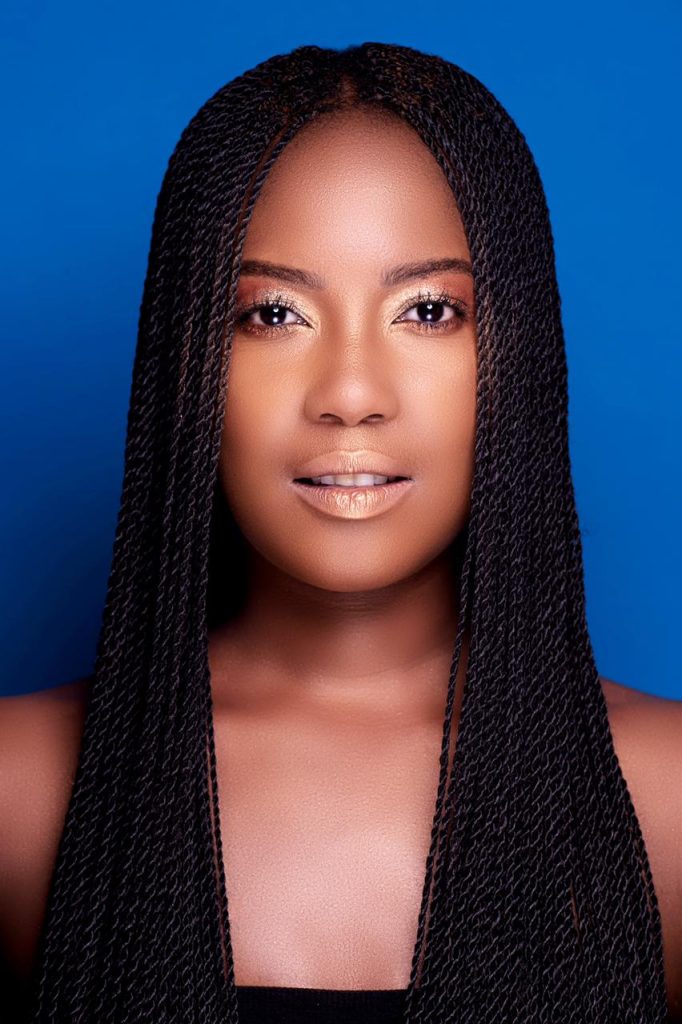 Prominent South African singer's portrait, Zamajobe with braids on a blue background studio shoot.