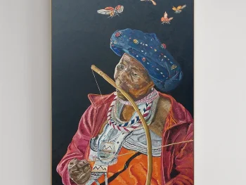 Elderly African woman with butterflies above her head in surreal setting.