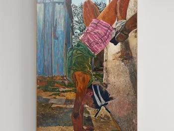 A girl standing upside down with her legs bent in Lotus position.