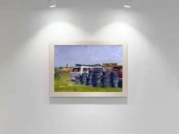 Taxi and stacked tyres in an open field.