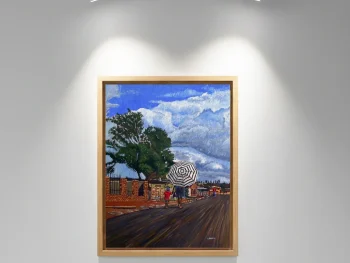 An African woman with a spider-pattern umbrella walking down the street with her young son beside her.